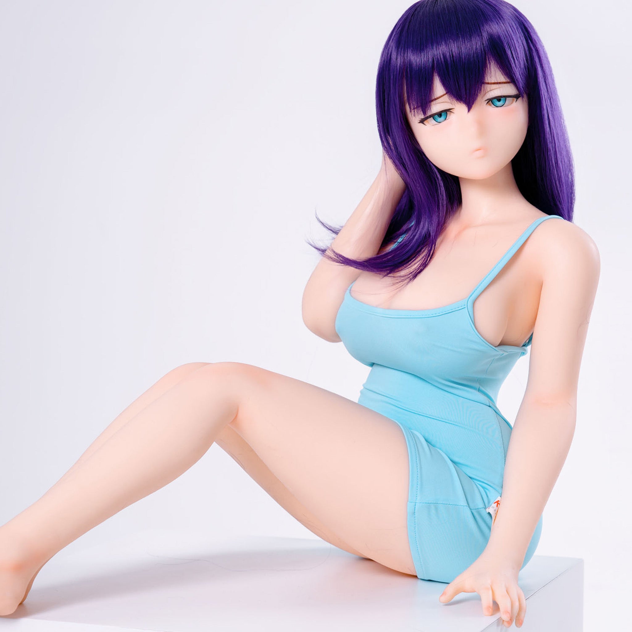 3ft 1in or 95cm tall mini Anime style silicone sex doll with large breasts, purple hair and blue eyes in a tight blue outfit.  Made by Irokebijin.
