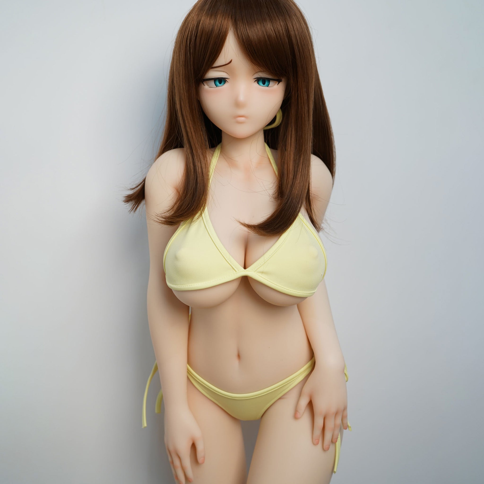 3ft 1in or 95cm tall mini Anime style silicone sex doll with large breasts, brown hair and blue eyes in a yellow bikini.  Made by Irokebijin.