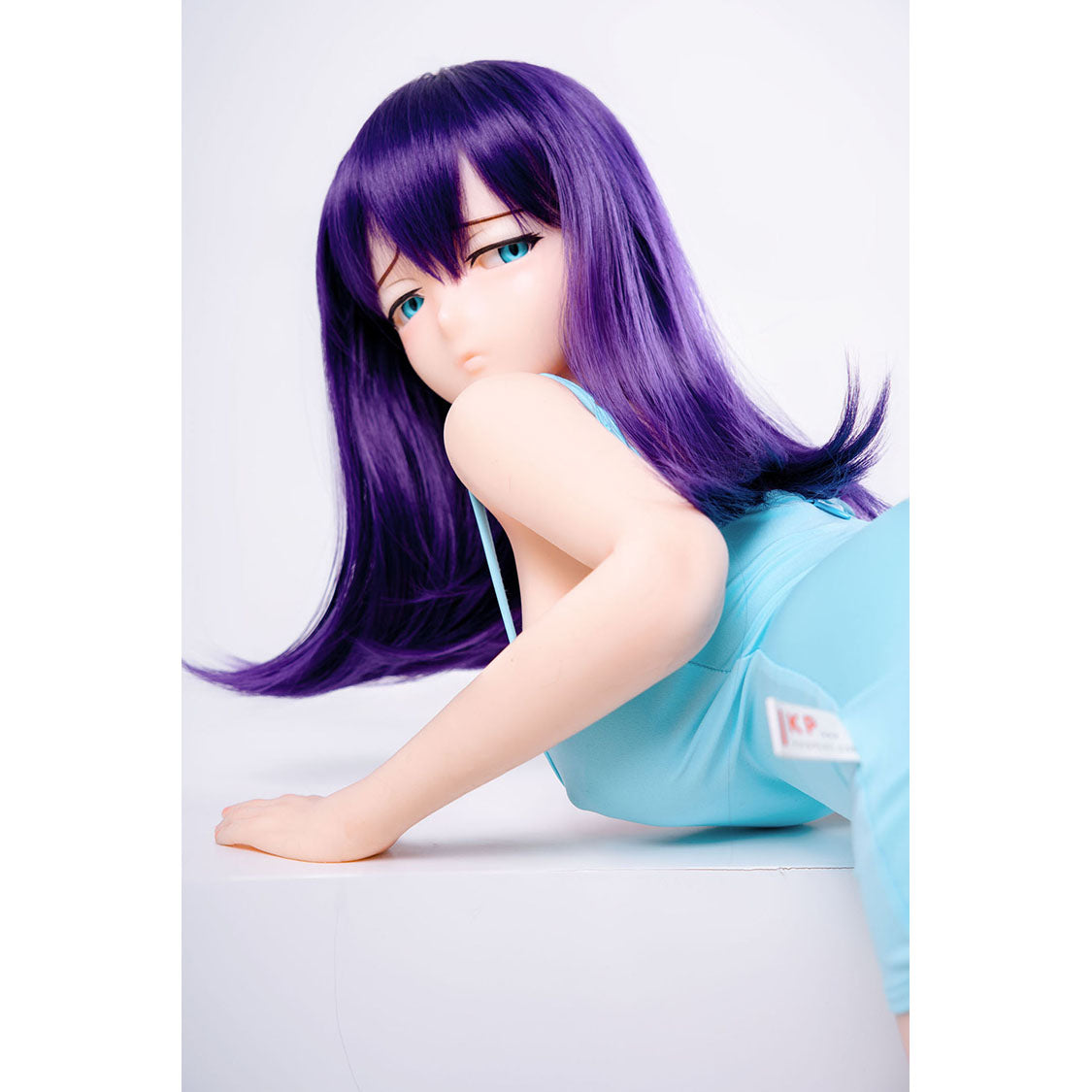 3ft 1in or 95cm tall mini Anime style silicone sex doll with large breasts, purple hair and blue eyes in a tight blue outfit.  Made by Irokebijin.