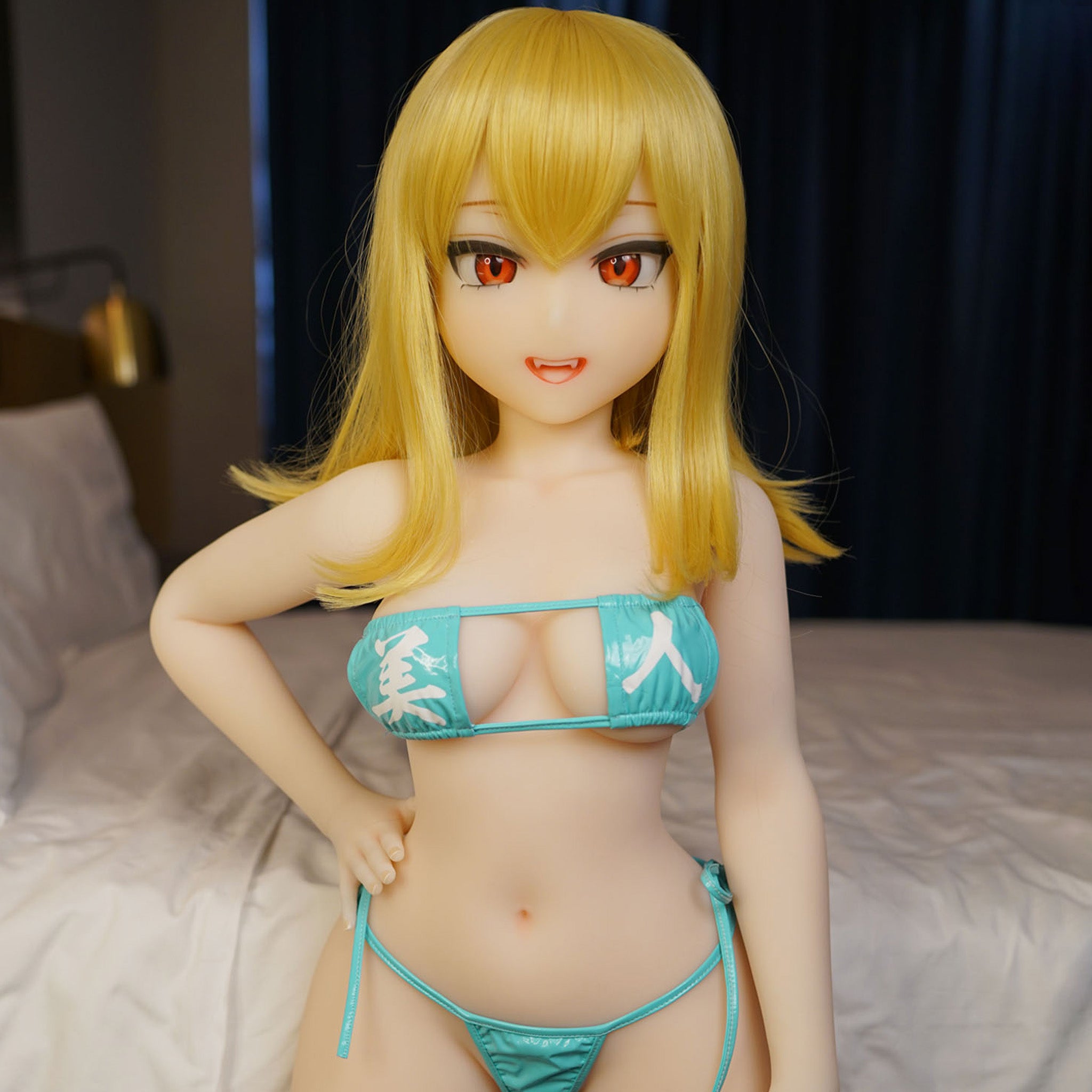 3ft 11in or 120cm tall Abby.  Mini Anime TPE sex doll with large breasts, long blonde hair,  red eyes and a blue bikini. Made by Irokebijin.