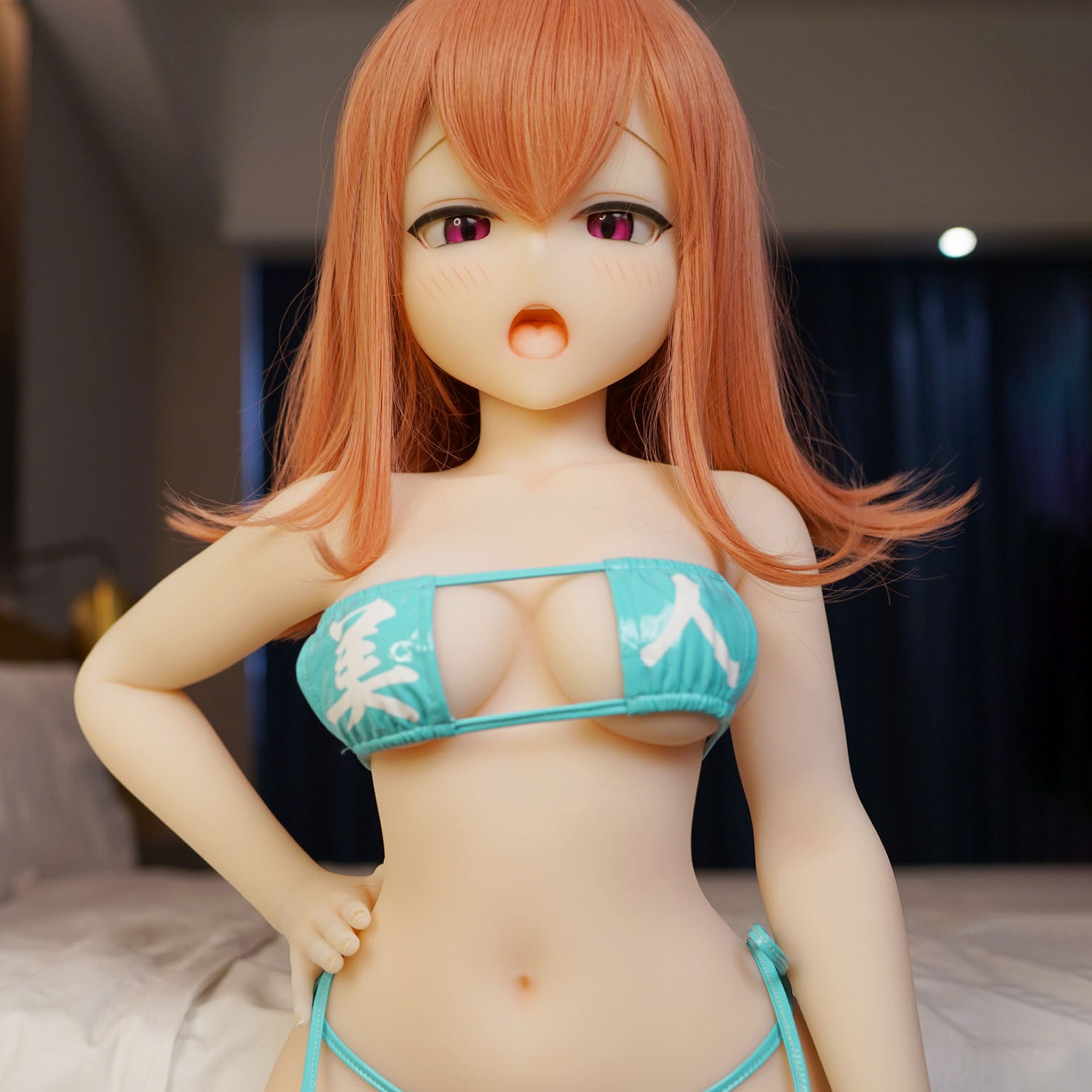 3ft 11in or 120cm tall Aiko.  Anime TPE sex doll with large breasts, long red hair, red eyes and a light blue bikini. Made by Irokebijin.