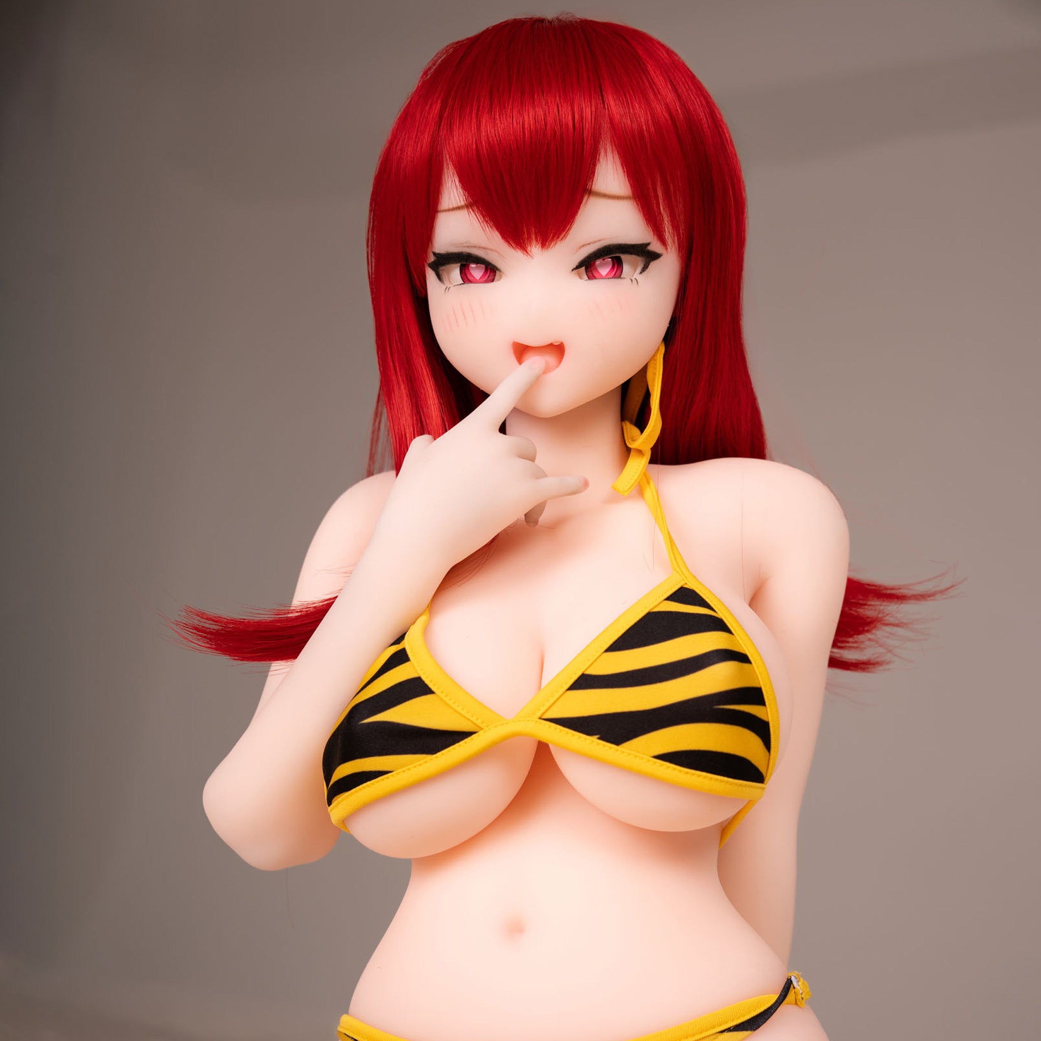 3ft 1in or 95cm tall Aoi.  Mini Anime silicone sex doll with large breasts, long red hair, heart eyes and a tiger striped bikini. Made by Irokebijin.