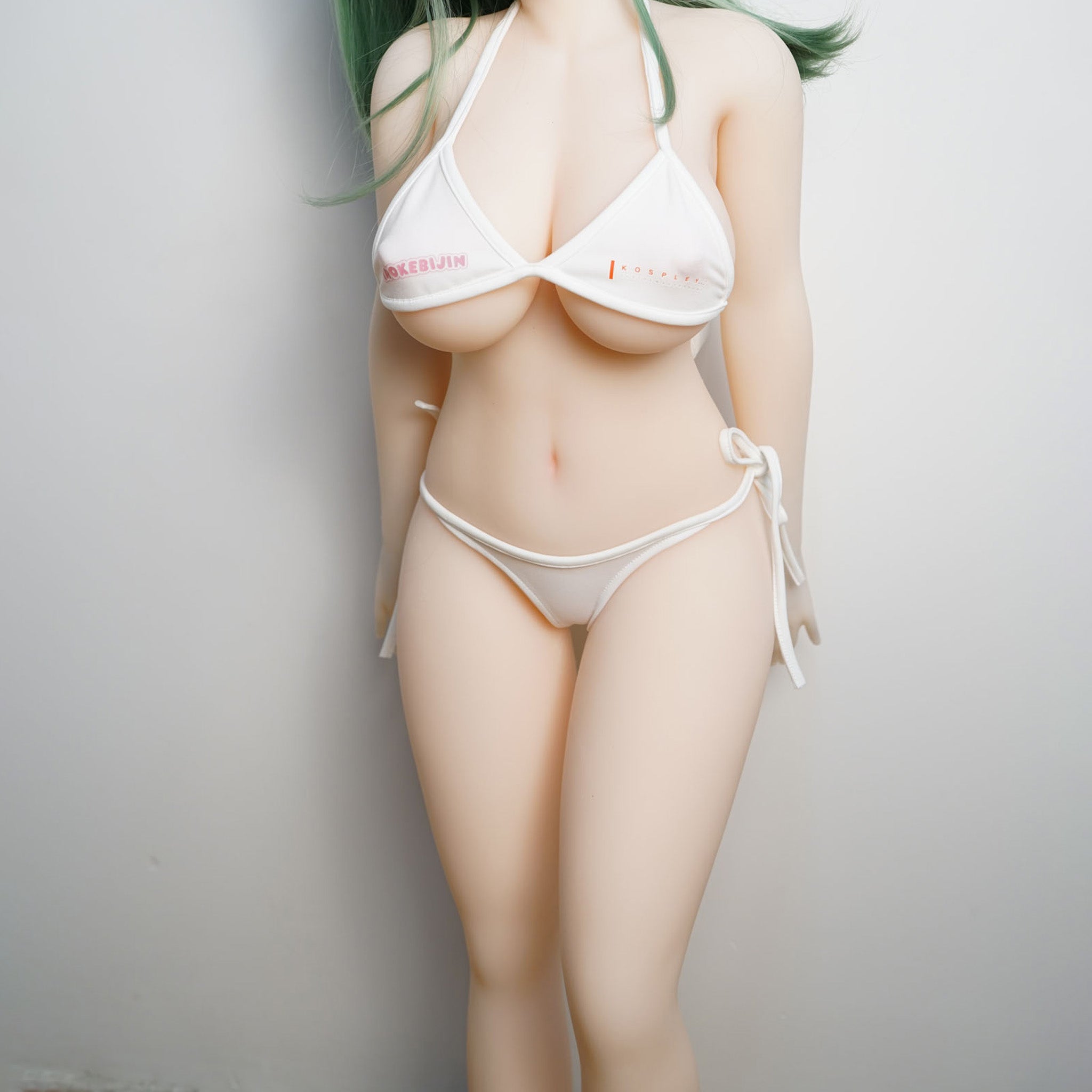 3ft 1in or 95cm tall Rico A.  Mini Anime TPE sex doll with large breasts, long green hair, yellow eyes and a white Irokebijin bikini. Made by Irokebijin.