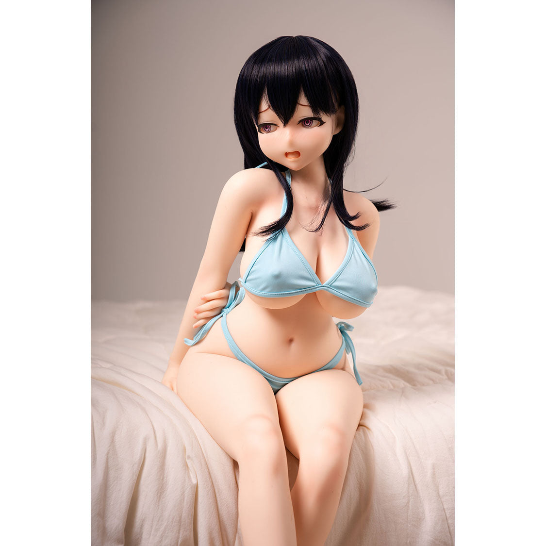 3ft 1in or 95cm tall mini Anime style silicone sex doll with large breasts, black hair and pink eyes in a blue bikini.  Made by Irokebijin.