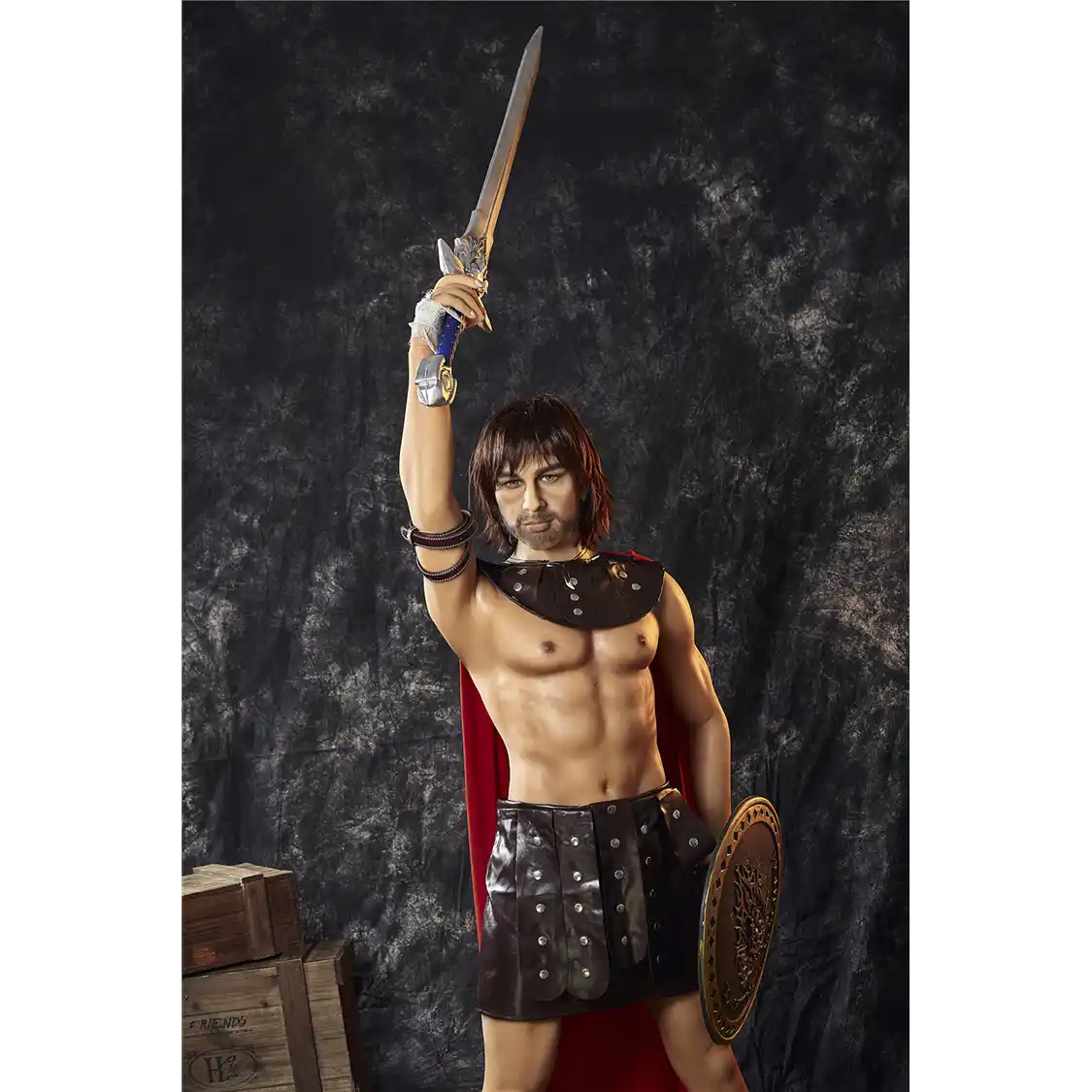 5ft 4in 162cm muscular White DILF sex doll with shaggy dark hair, stubble and a large penis in a gladiator outfit.