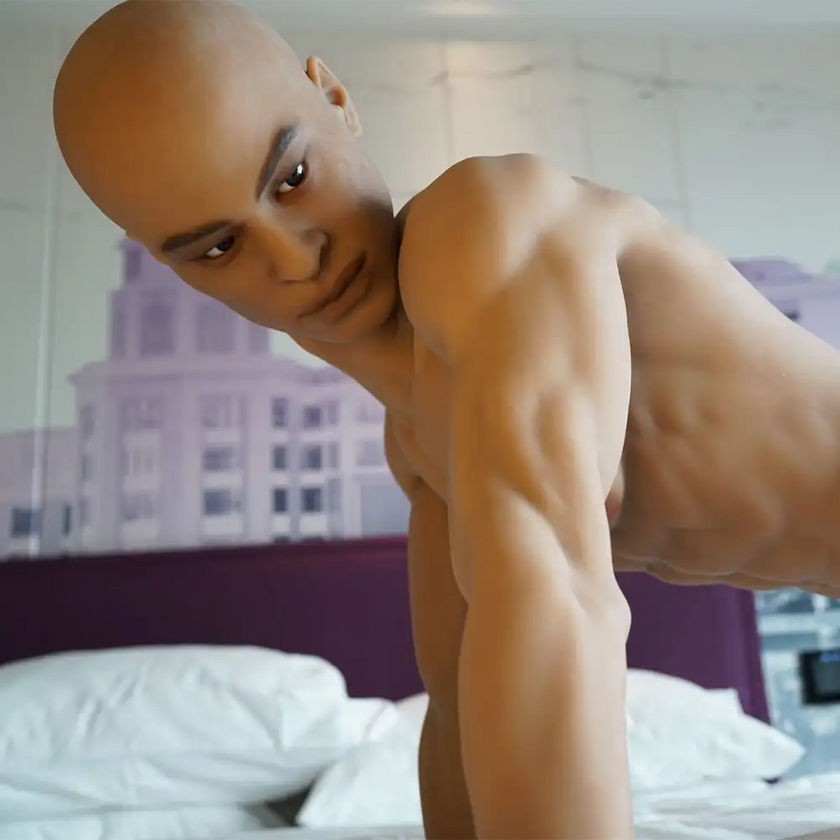 5ft 7in 170cm muscular Black male sex doll with abs, giant penis and blonde hair and blue eyes in gray underwear made by Doll Forever.