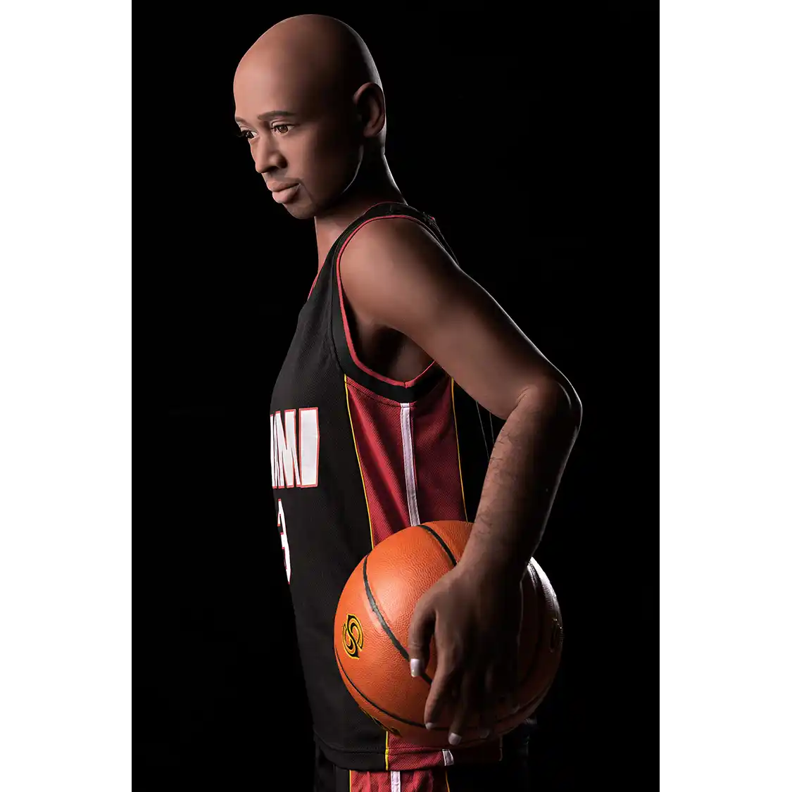 5ft 9in 175cm muscular Black male sex doll bald with a large penis dressed in a basketball outfit.