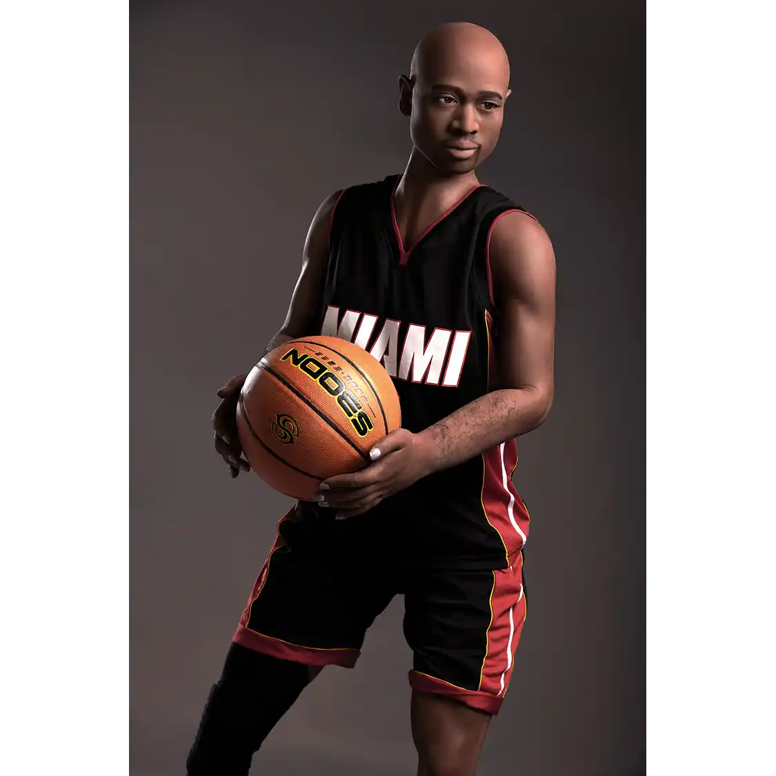 5ft 9in 175cm muscular Black male sex doll bald with a large penis dressed in a basketball outfit.