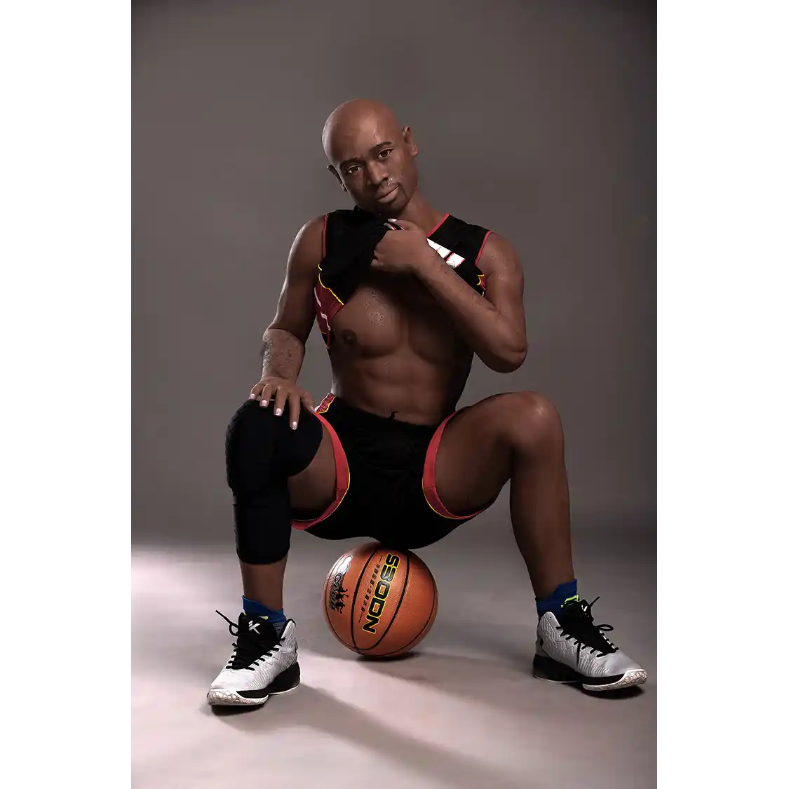 5ft 9in 175cm muscular Black male sex doll bald with a large penis dressed in a basketball outfit.