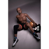 5ft 9in 175cm muscular Black male sex doll bald with a large penis dressed in a basketball outfit.