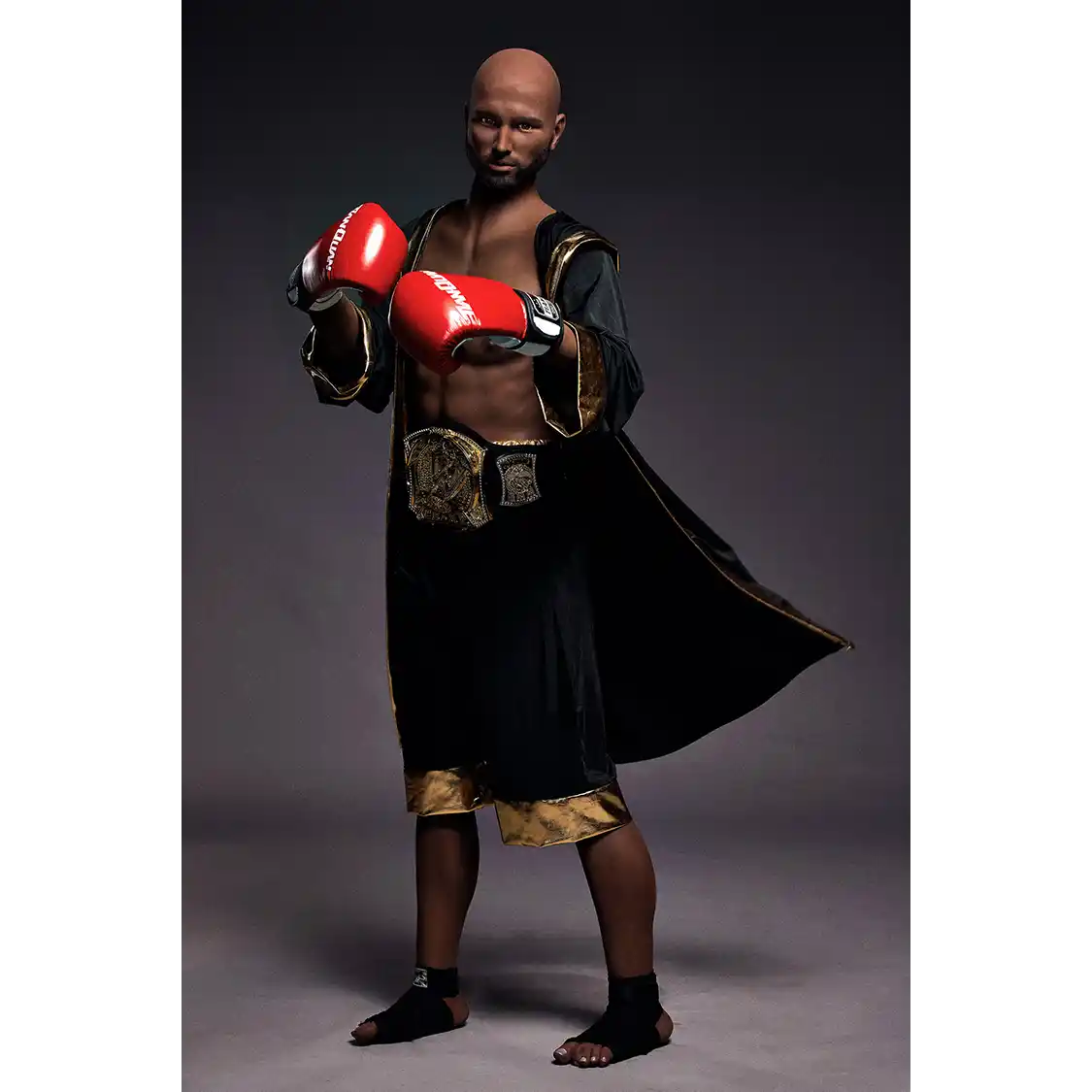 5ft 9in 175cm muscular Black male sex doll bald with a large penis dressed in a boxing outfit.