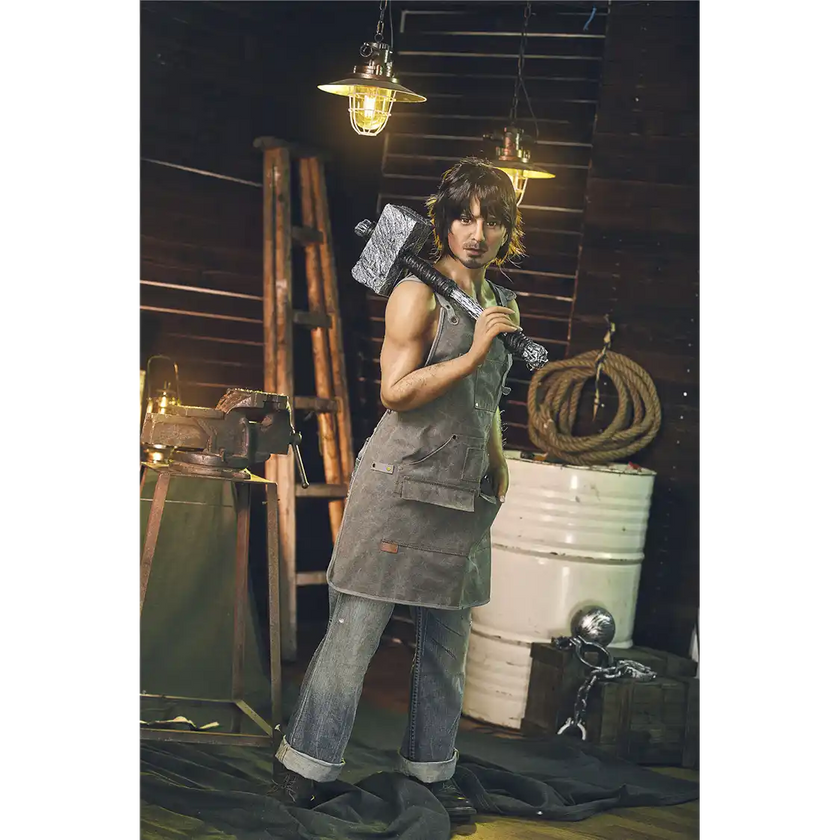 5ft 4in 162cm muscular White male sex doll with dark hair and a large penis in a blacksmiths outfit.