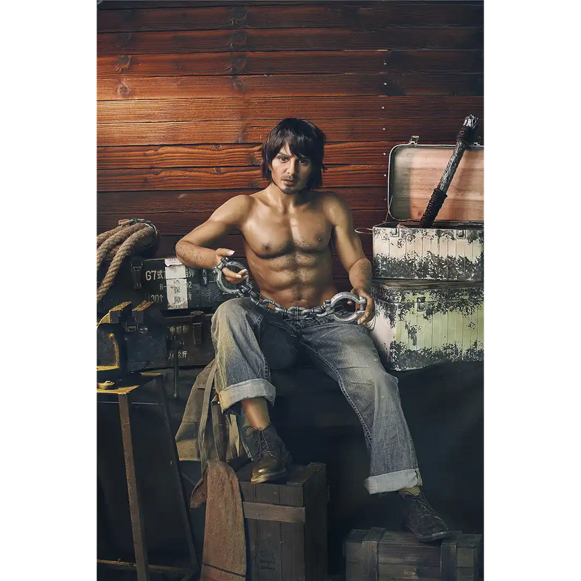 5ft 4in 162cm muscular White male sex doll with dark hair and a large penis in a blacksmiths outfit.