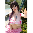 5ft 4in or 163cm curvy white female hybrid sex doll with long legs, long dark hair, large breasts, large butt, and brown eyes in a pink top and pink exercise pants.