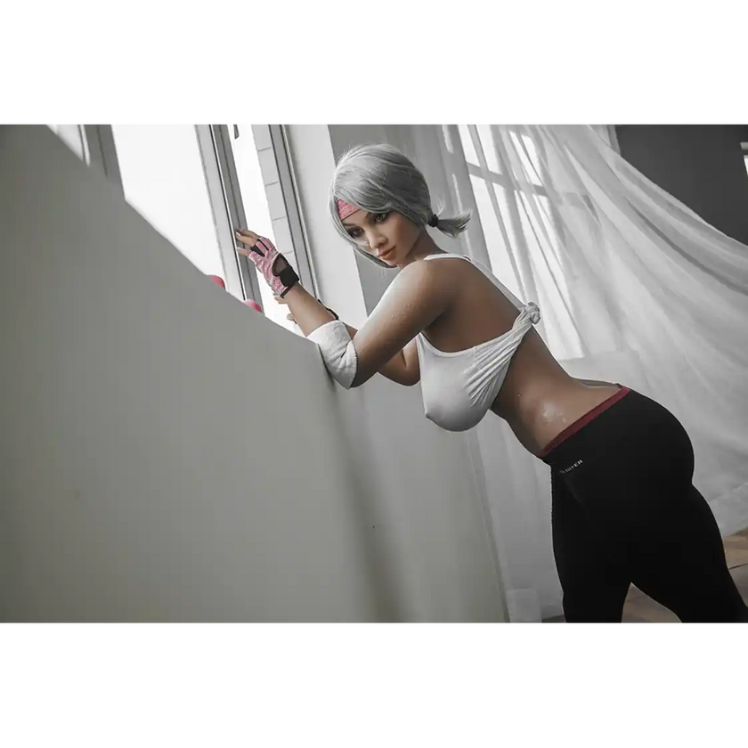 5ft 2in 158cm curvy Asian TPE sex doll with silver hair, large I cup breasts brown eyes and tanned skin in sports bra and tight pants.