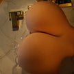 Very large and round TPE sex doll butt with fair skin.