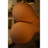 Very large and round TPE sex doll butt with fair skin.