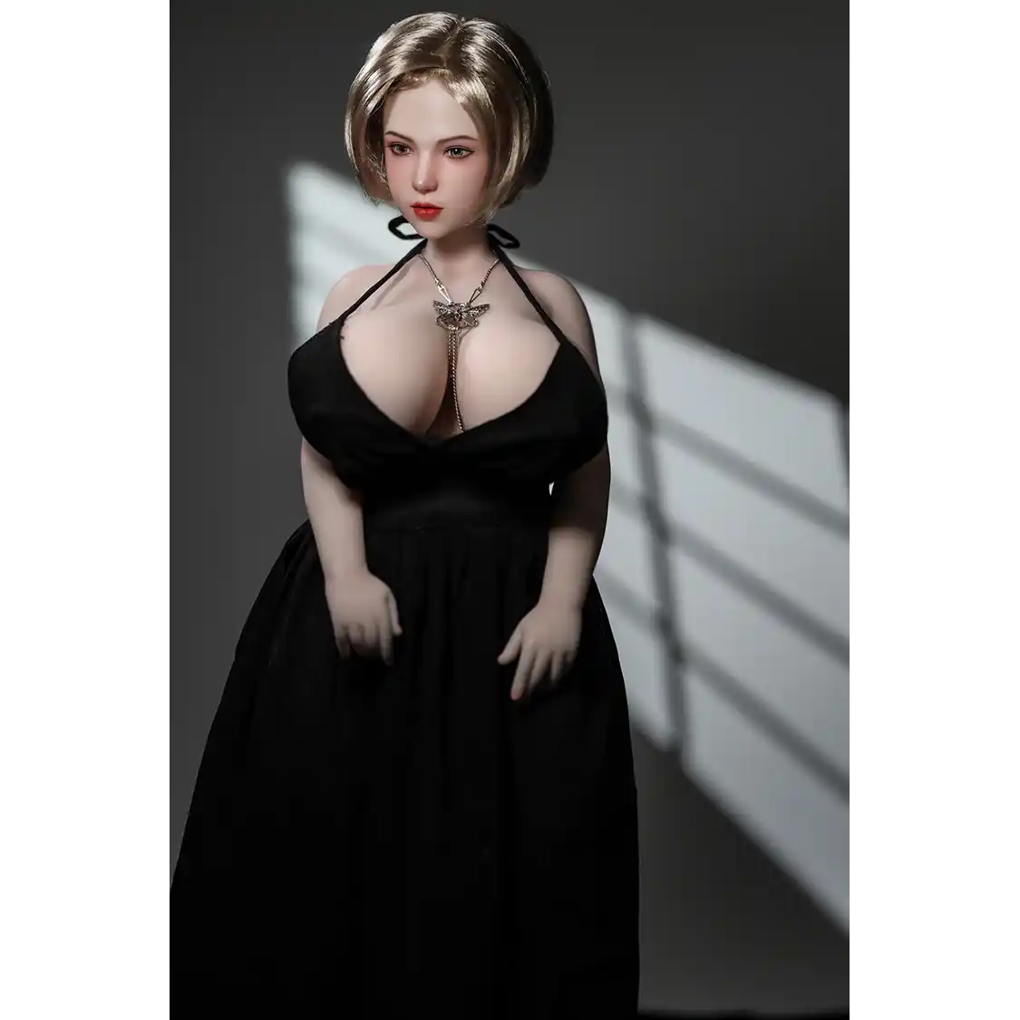 1ft 11in 60cm white female mini silicone sex doll with blonde hair, light skin and extra large breasts.