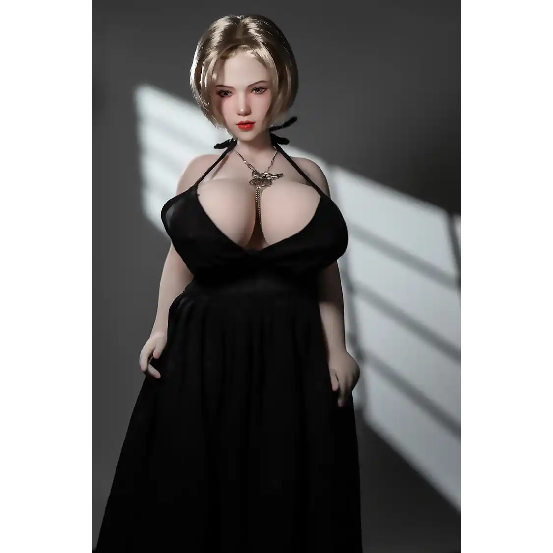 1ft 11in 60cm white female mini silicone sex doll with blonde hair, light skin and extra large breasts.