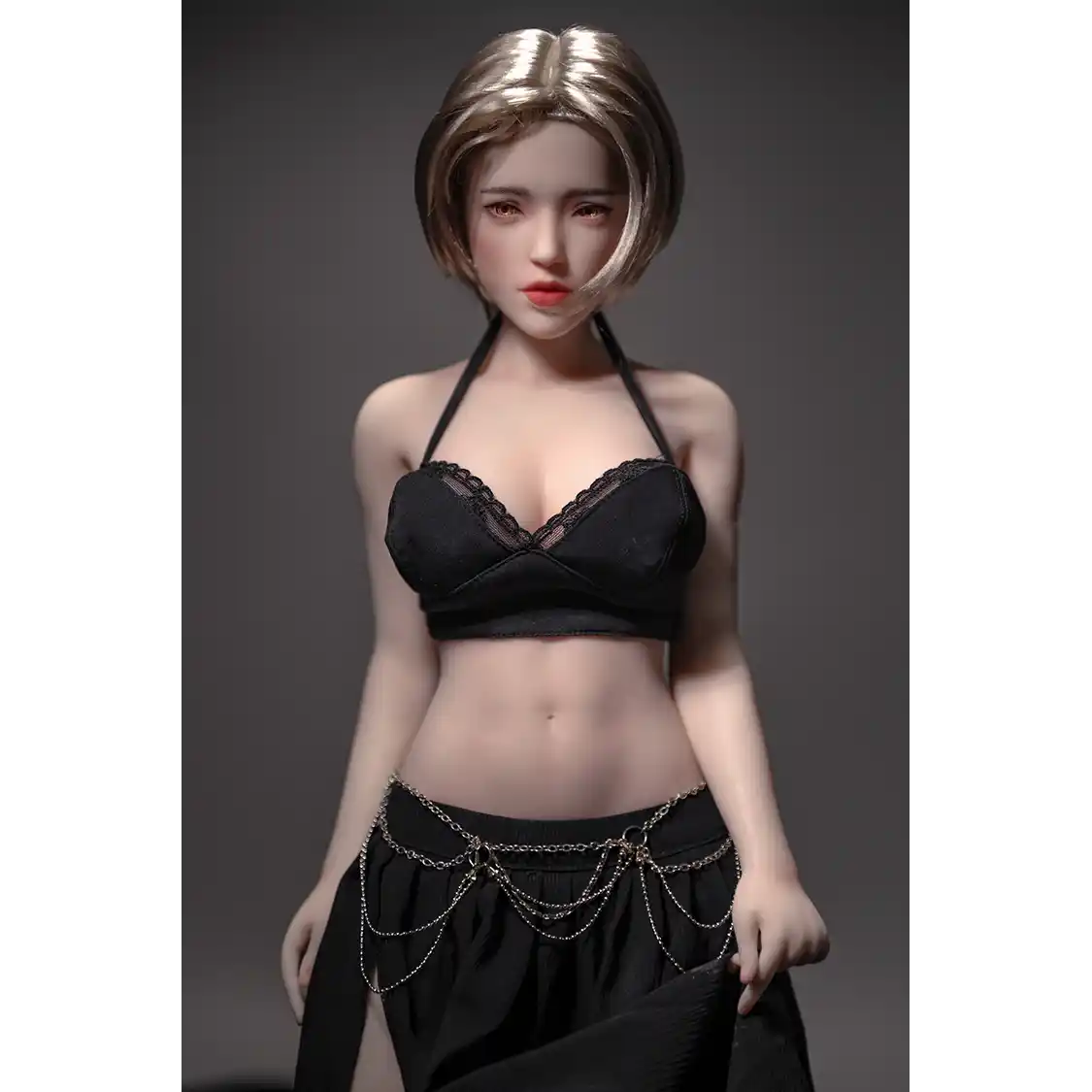 1ft 11in 60cm white female mini silicone sex doll with blonde hair, light skin and large breasts.