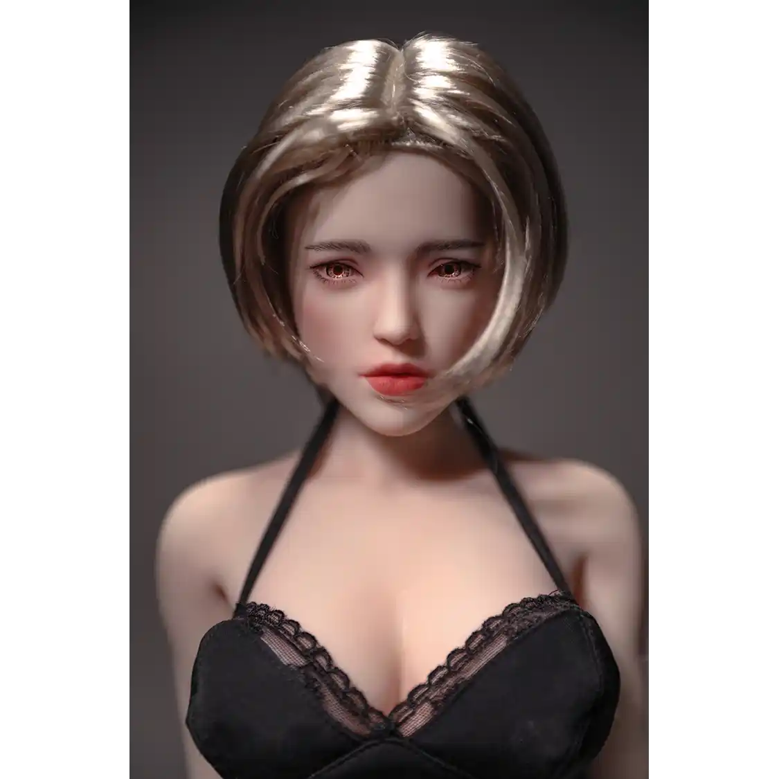 1ft 11in 60cm white female mini silicone sex doll with blonde hair, light skin and large breasts.