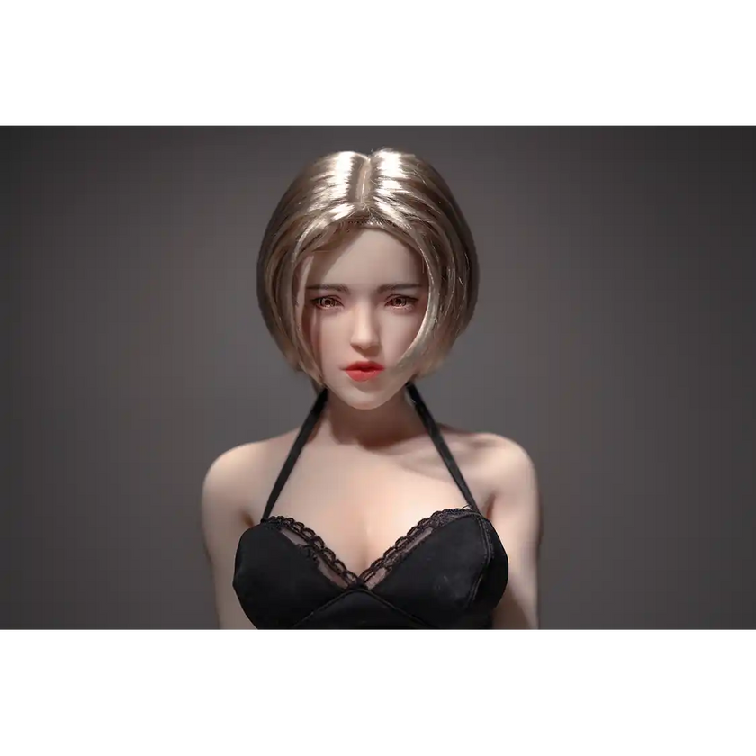 1ft 11in 60cm white female mini silicone sex doll with blonde hair, light skin and large breasts.