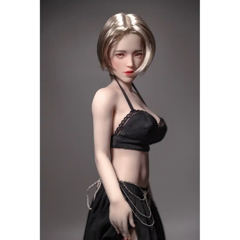 1ft 11in 60cm white female mini silicone sex doll with blonde hair, light skin and large breasts.