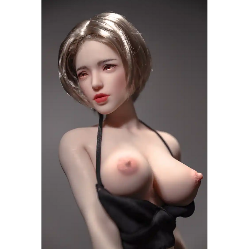 1ft 11in 60cm white female mini silicone sex doll with blonde hair, light skin and large breasts.