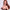 2ft 60cm mini anime sex doll Hedy. Silicone body construction, ultra realistic breasts, and body, fair skin, long red hair and a curvy body in a sheer top, black fur  coat, brown mini skirt and brown tube top.