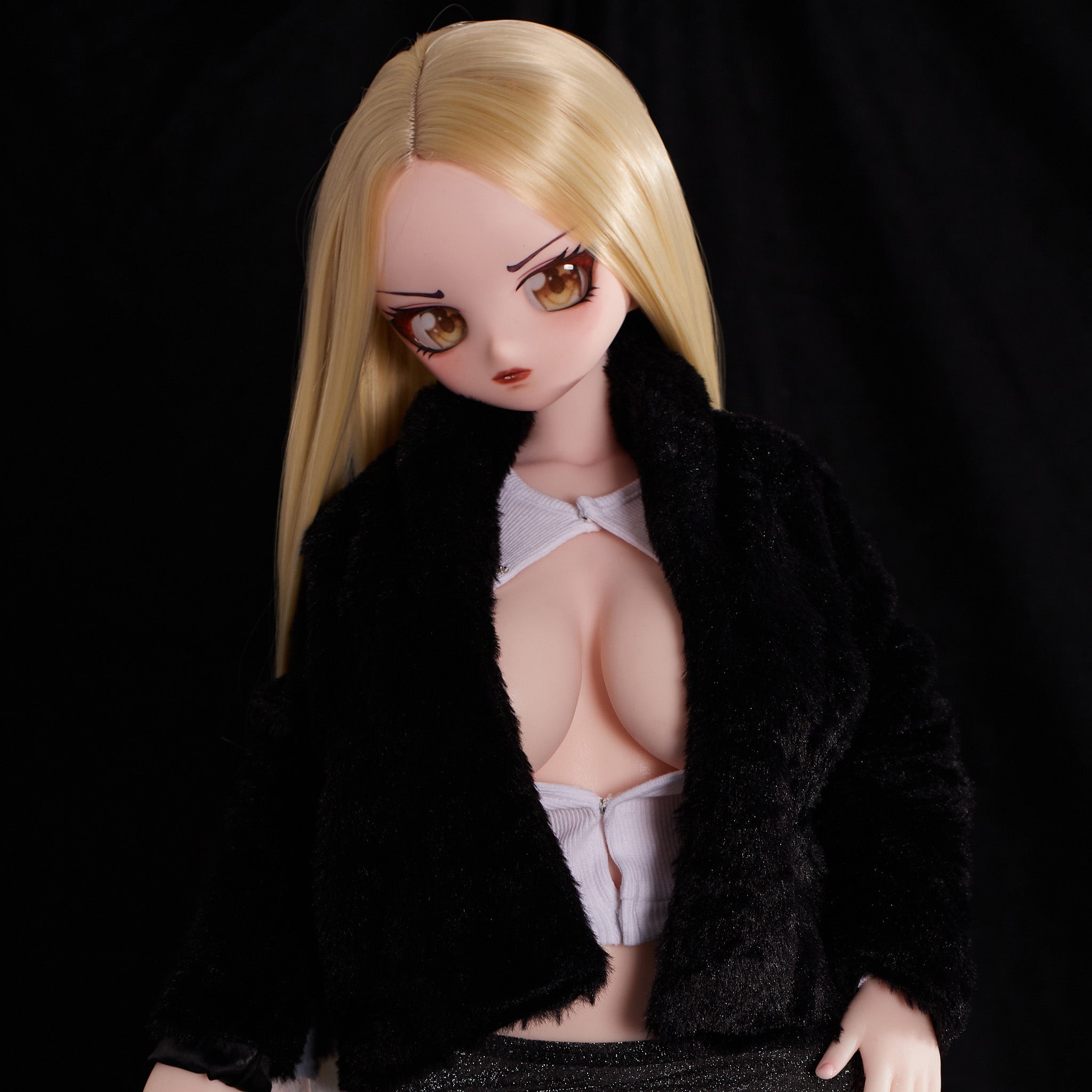 2ft 9in or 85cm tall mini anime sex doll Hikari. Silicone body construction, large breasts, fair skin, long blonde hair and a slim athletic body in a sexy black jacket and black skirt.