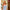5ft 7in 170cm tall thin large breasted G-cup TPE sex doll with blonde hair, brown eyes and fair skin in a blue skirt.