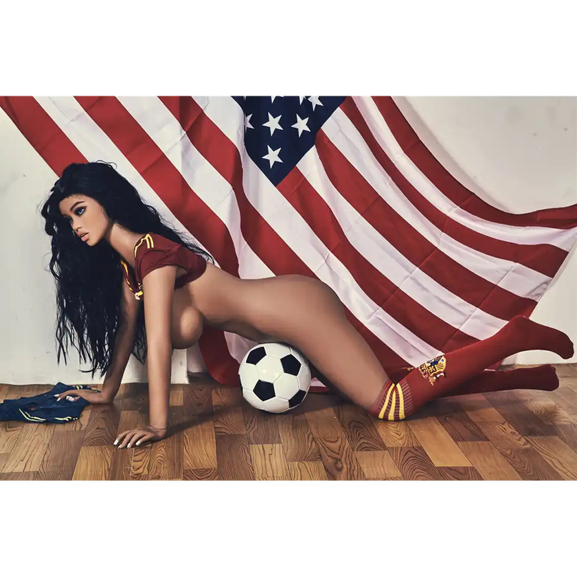 5ft 4in 163cm curvy athletic TPE sex doll with G cup breasts in a soccer outfit with long wavy black hair.