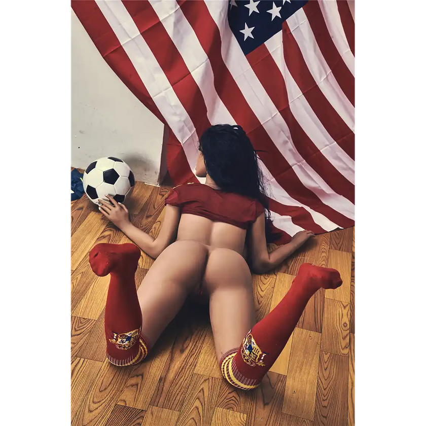 5ft 4in 163cm curvy athletic TPE sex doll with G cup breasts in a soccer outfit with long wavy black hair.