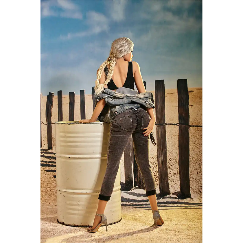 5ft 3in 159cm curvy black TPE sex doll with long braided blonde hair, large E cup breasts and blue eyes in a western outfit.