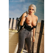 5ft 3in 159cm curvy black TPE sex doll with long braided blonde hair, large E cup breasts and blue eyes in a western outfit.