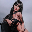 5ft 2in 158cm white female tpe sex doll with long straight black hair, large breasts, and a slim curvy figure in black bondage gear.