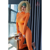 5ft 4in 163cm tall curvy blonde TPE sex doll with large E-cup breasts, brown eyes and curly blonde hair.