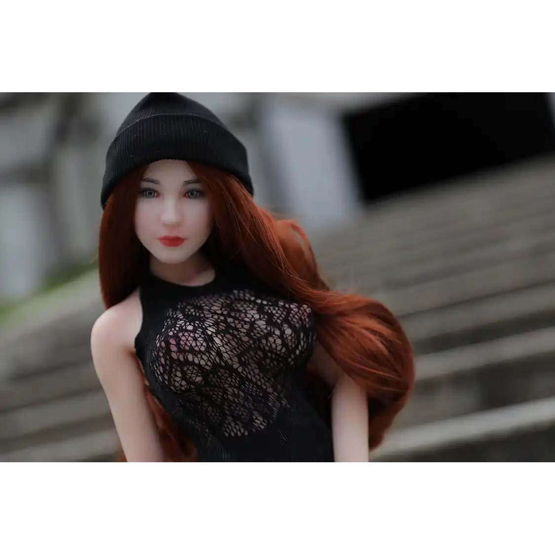 1ft 11in 60cm white female mini silicone sex doll with long red hair, light skin and large breasts.