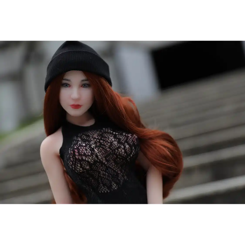 1ft 11in 60cm white female mini silicone sex doll with long red hair, light skin and large breasts.