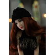 1ft 11in 60cm white female mini silicone sex doll with long red hair, light skin and large breasts.