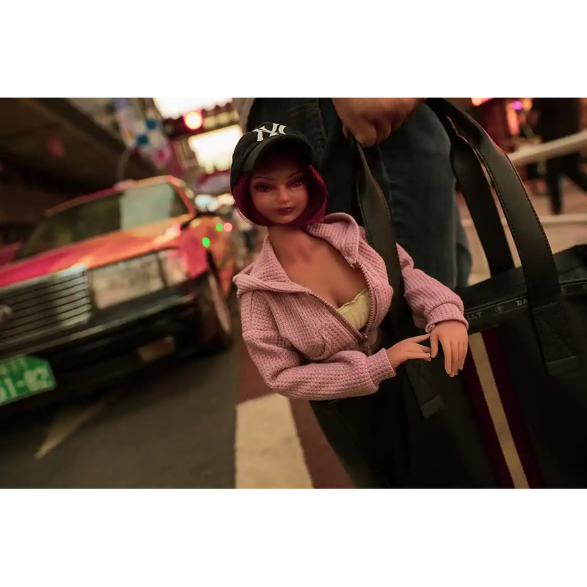 1ft 11in 60cm anime style female mini silicone sex doll with red hair, light skin and large breasts.