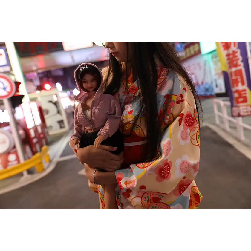 1ft 11in 60cm anime style female mini silicone sex doll with red hair, light skin and large breasts.