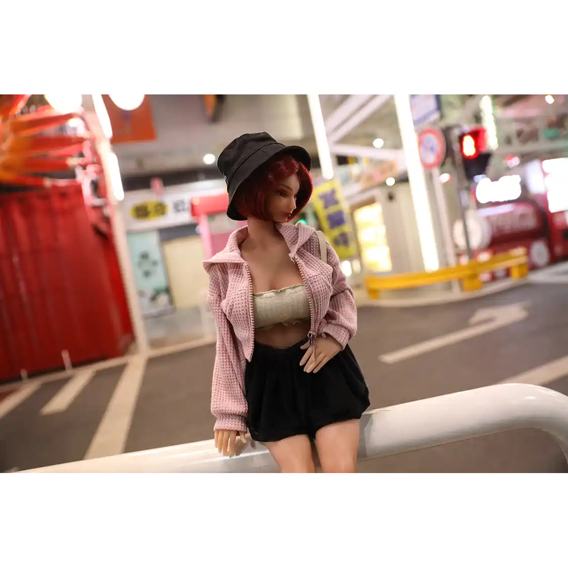 1ft 11in 60cm anime style female mini silicone sex doll with red hair, light skin and large breasts.