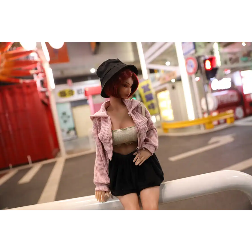 1ft 11in 60cm anime style female mini silicone sex doll with red hair, light skin and large breasts.