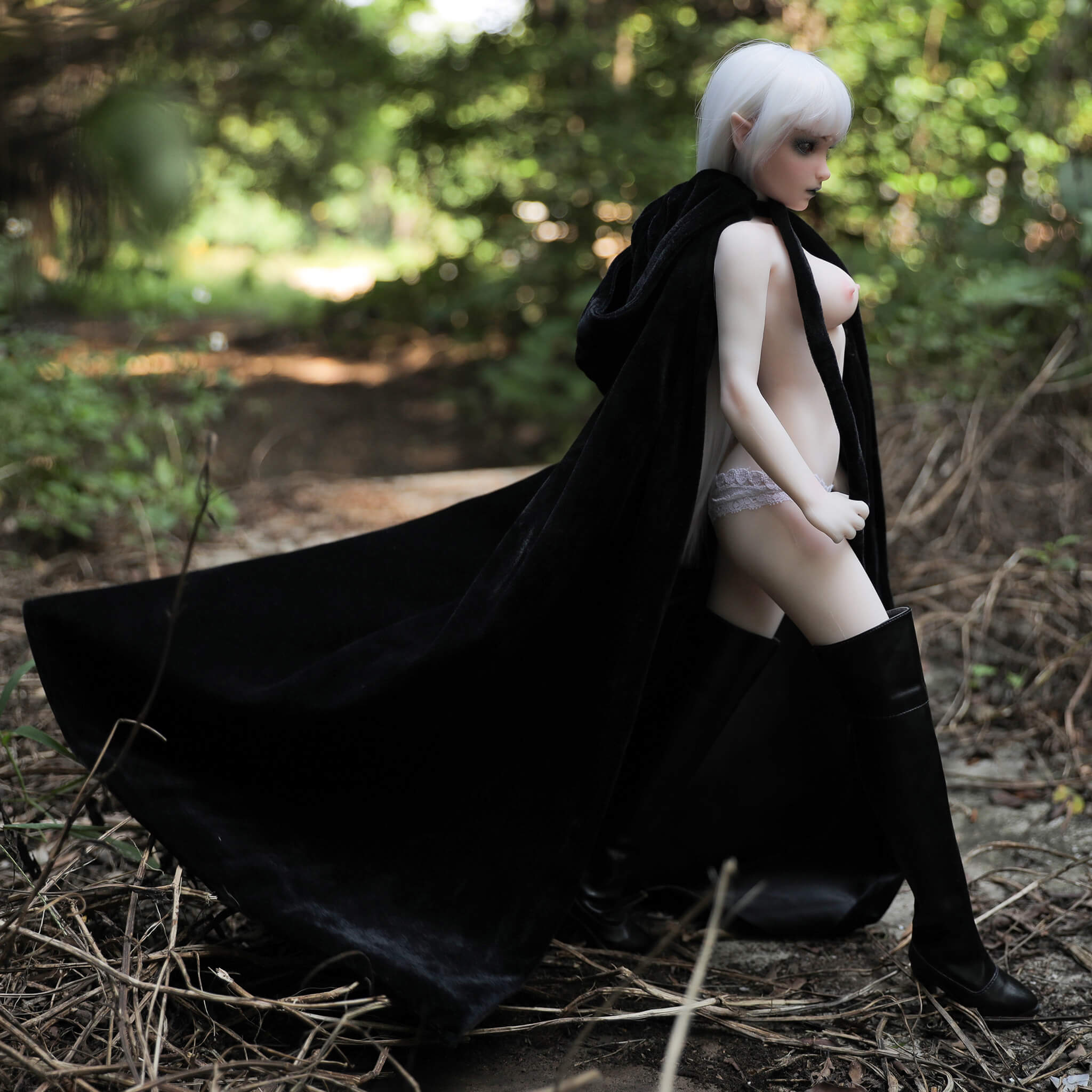 1ft 11in 60cm mini silicone elf sex doll with white hair, silver eyes small breasts and a slim athletic figure.