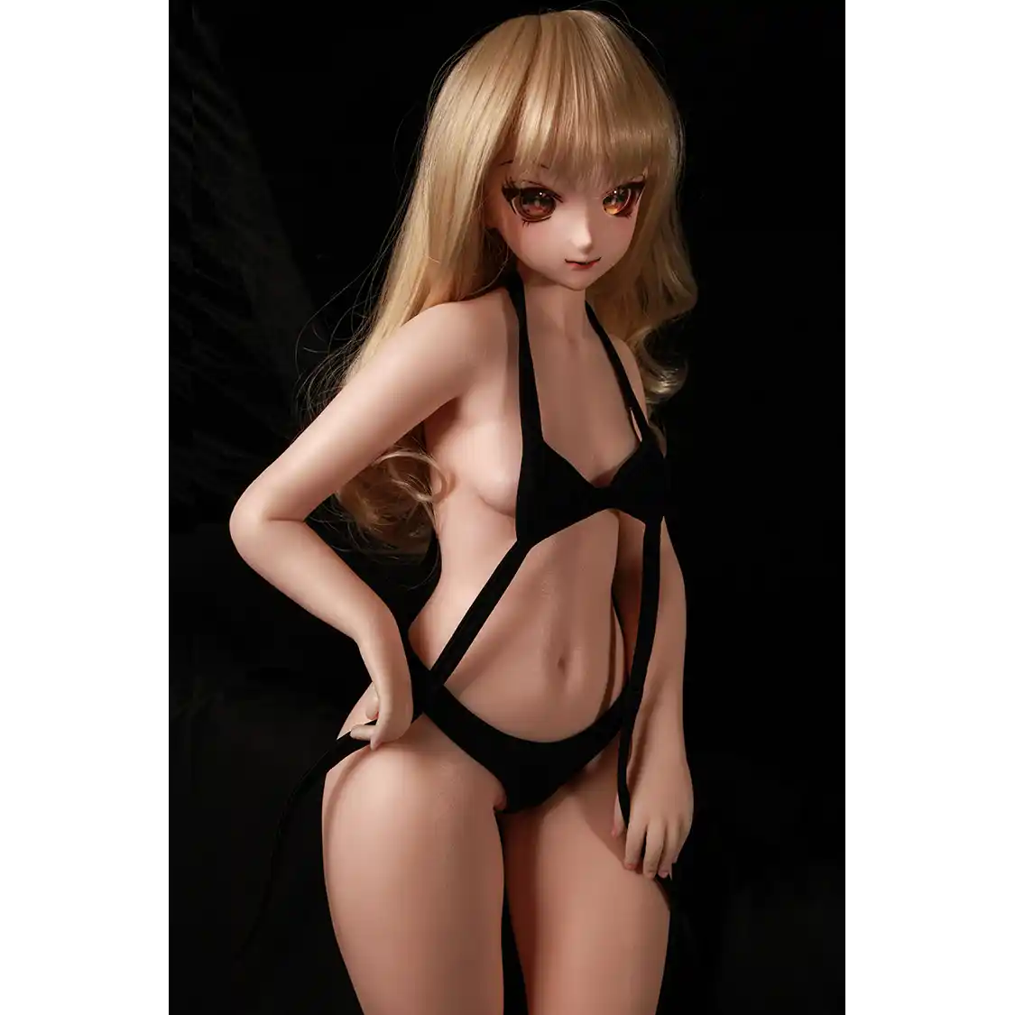 2ft 60cm anime style female mini silicone sex doll with medium breasts, fair skin and a fit athletic body in a black bikini.