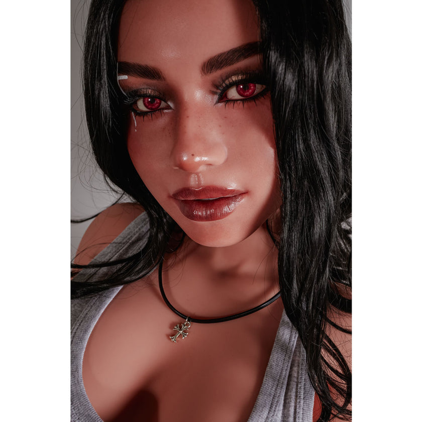 Reese 154 cm Latina hybrid E-cup sex doll in grey tank top kneeling on dark floor – Climax Collection