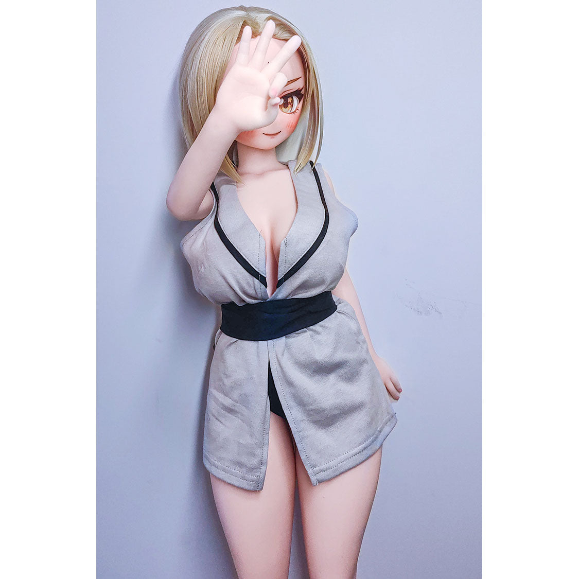 2ft 9in or 85cm tall mini anime sex doll Reyna. Silicone body construction, large breasts, fair skin, jaw length blonde hair and a slim athletic body in a sexy Asian style fantasy outfit.