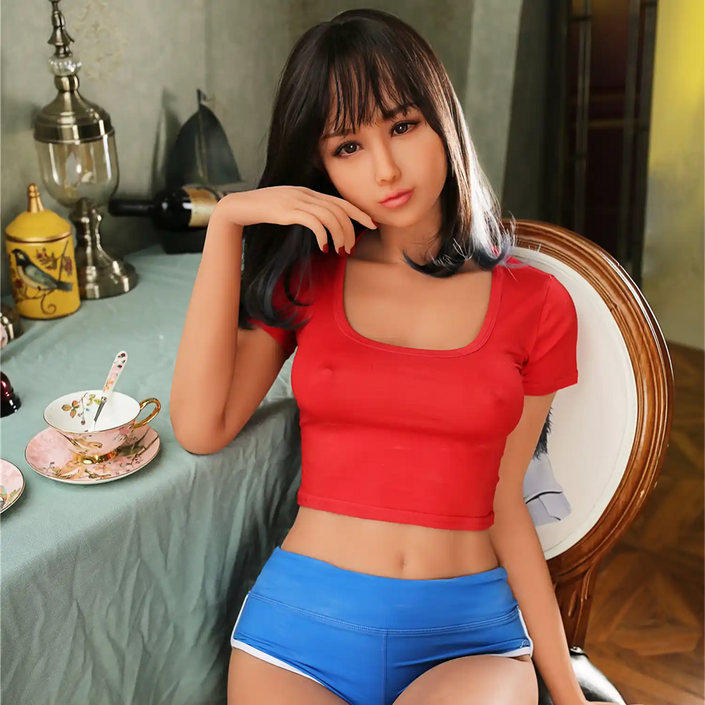 5ft 6in 166cm slim Asian TPE sex doll with shoulder length black hair, small breasts and brown eyes in a red shirt and blue shorts.