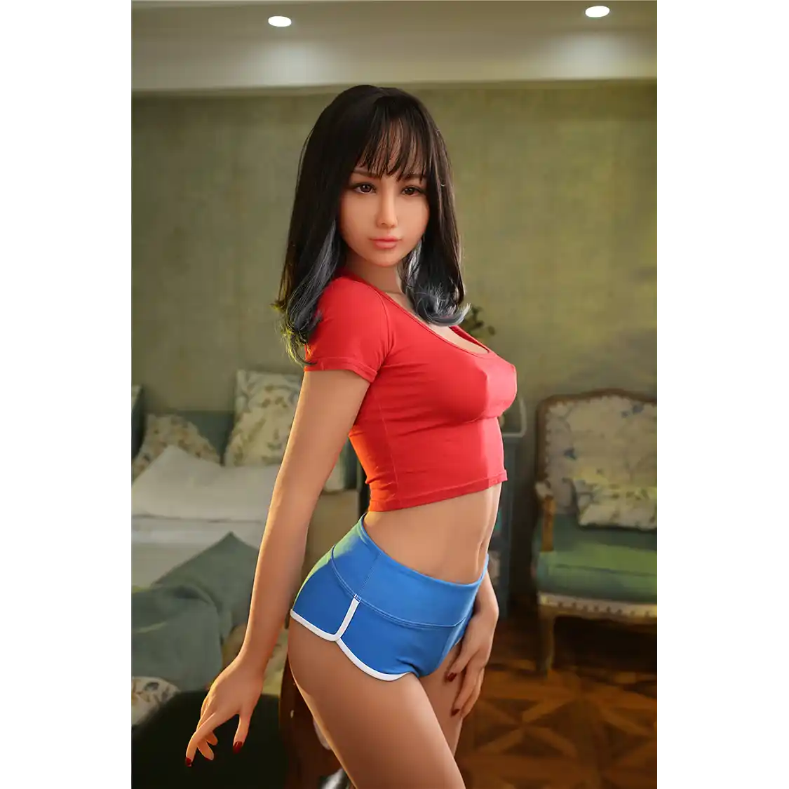 5ft 6in 166cm slim Asian TPE sex doll with shoulder length black hair, small breasts and brown eyes in a red shirt and blue shorts.